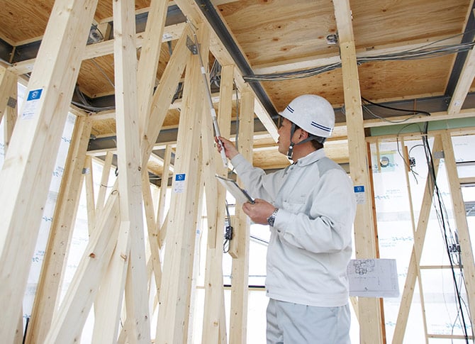 住宅の耐震強度をチェックするスタッフ